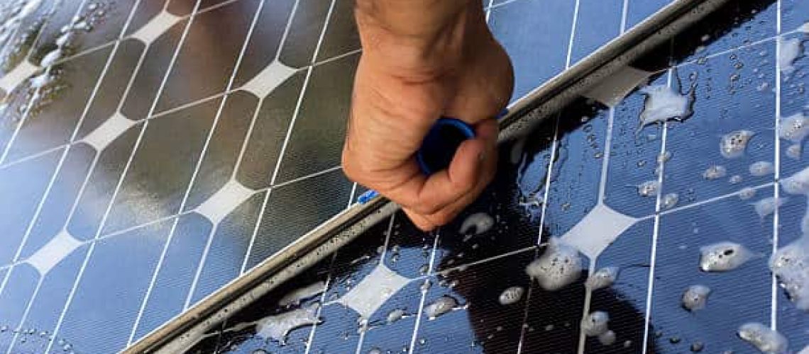 Close up image of a person cleaning a photovoltaic panel  for better production (ISO 200). All my images have been processed in 16 Bits and transfer down to 8 before uploading.